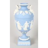 A WEDGWOOD BLUE AND WHITE CLASSIC TWO HANDLED URN. 9.5ins high.
