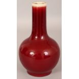 A 19TH/20TH CENTURY CHINESE SANG-DE-BOEUF PORCELAIN BOTTLE VASE, applied with a faintly streaked