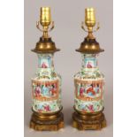 A PAIR OF 19TH CENTURY CHINESE CANTON PORCELAIN VASES, fitted for electricity with French ormolu