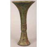 A CHINESE BRONZE GU VASE, of archaic form and design, 9.8in high.
