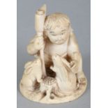 A SIGNED JAPANESE MEIJI PERIOD IVORY OKIMONO OF A BOY WITH TWO RABBITS, the boy kneeling and holding