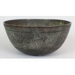 AN EARLY 20TH CENTURY CHINESE BRONZE BOWL, the sides cast in shallow relief with a panels of a