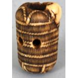 A JAPANESE MEIJI PERIOD IVORY NETSUKE OF A RAT ON A STRAW BALE, unsigned, the rat's head burrowed