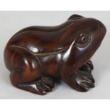 A JAPANESE CARVED WOOD NETSUKE OF A FROG, unsigned, 1.75in long & 1in high.