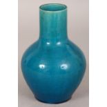 A 19TH/20TH CENTURY CHINESE TURQUOISE GLAZED PORCELAIN VASE, the sides applied with a densely