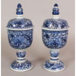 A PAIR OF CHINESE BLUE & WHITE PORCELAIN STEM BOWLS & COVERS, each decorated with scrolling peony,