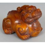 A CHINESE HORN CARVING OF A MYTHICAL ANIMAL, 3.4in long & 2.5in high.