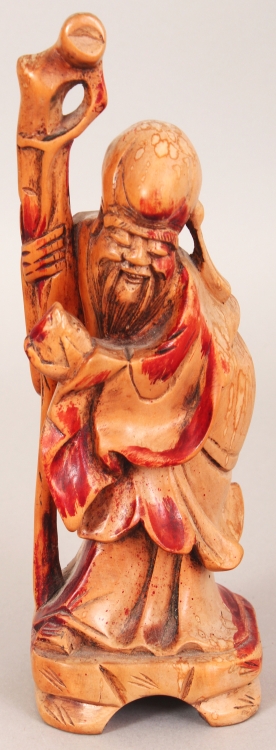 A 19TH/20TH CENTURY CARVED & STAINED WOOD FIGURE OF SHOU LAO, bearing a peach and a staff, 7.4in