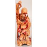 A 19TH/20TH CENTURY CARVED & STAINED WOOD FIGURE OF SHOU LAO, bearing a peach and a staff, 7.4in