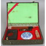 A 20TH CENTURY CHINESE CASED WRITING SET, contained in a fitted box, and comprising brushes, ink