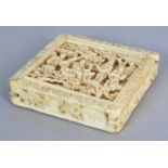 A 19TH CENTURY CHINESE CANTON IVORY PUZZLE BOX, of square form and with a sliding cover, the