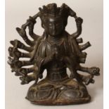 A 16TH/17TH CENTURY CHINESE BRONZE FIGURE OF A MULTI-ARMED BUDDHIST DEITY, seated in dhyanasana, his
