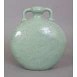 A CHINESE CELADON GLAZED DRAGON MOON FLASK, with underglaze moulded decoration, the base with an