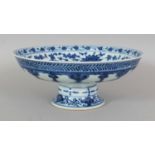 A CHINESE BLUE & WHITE PORCELAIN STEM BOWL, the interior decorated in a 'heaped and piled' Ming