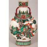 A 19TH CENTURY CHINESE FAMILLE VERTE PORCELAIN PILGRIM'S FLASK, painted with scenes of conversing