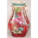 AN UNUSUAL 19TH CENTURY CHINESE FAMILLE ROSE SANG-DE-BOEUF PORCELAIN ARROW HU VASE, painted with