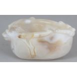 A CHINESE AGATE LIBATION BOWL, the predominantly white stone with russet striations, 3.5in long &