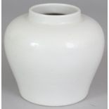 A CHINESE WHITE GLAZED PORCELAIN VASE, undecorated, the base incised beneath the glaze with a six-