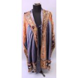 AN EARLY 20TH CENTURY CHINESE EMBROIDERED SILK ROBE BEARING A LIBERTY & CO LABEL, decorated in stain