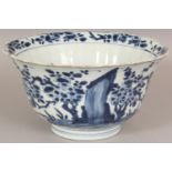 A CHINESE KANGXI PERIOD BLUE & WHITE FLUTED PORCELAIN BOWL, the sides painted with a garden scene of