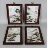 A SET OF FOUR CHINESE HARDWOOD FRAMED RECTANGULAR PORCELAIN PANELS, each decorated with