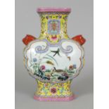 A GOOD QUALITY CHINESE FAMILLE ROSE MOULDED PORCELAIN VASE, the sides decorated with ruyi form
