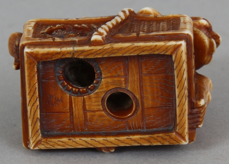 A SIGNED JAPANESE MEIJI PERIOD STAINED IVORY NETSUKE OF A DEMON, lying astride a rectangular reed - Image 8 of 9