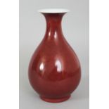 A CHINESE COPPER RED YUHUCHUNPING PORCELAIN VASE, applied with a mottled glaze, the base with a