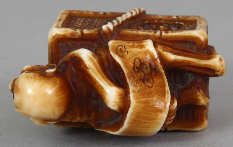 A SIGNED JAPANESE MEIJI PERIOD STAINED IVORY NETSUKE OF A DEMON, lying astride a rectangular reed - Image 7 of 9