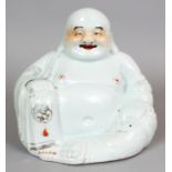AN EARLY 20TH CENTURY CHINESE PORCELAIN FIGURE OF BUDAI, seated and holding a string of beads, the