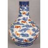 A LARGE CHINESE BLUE & WHITE PORCELAIN BOTTLE VASE, decorated with bats in iron-red amidst cloud
