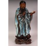 A LARGE EARLY 20TH CENTURY CHINESE FLAMBE GLAZED STONEWARE FIGURE OF A STANDING SAGE