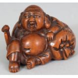 A JAPANESE MEIJI PERIOD CARVED WOOD NETSUKE OF HOTEI, unsigned, holding a fan and leaning