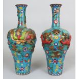 A LARGE PAIR OF CHINESE CLOISONNE DRAGON & PHOENIX VASES, one cast in relief with dragons, the other