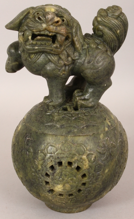 A CHINESE GREEN HARDSTONE CENSER & COVER, in the form of a Buddhistic Lion standing on a brocaded