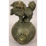 A CHINESE GREEN HARDSTONE CENSER & COVER, in the form of a Buddhistic Lion standing on a brocaded