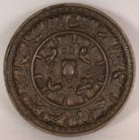 A SMALL CHINESE TANG STYLE LION & VINE BRONZE MIRROR, possibly early, 3.9in diameter.
