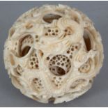 AN EARLY 20TH CENTURY CHINESE CONCENTRIC IVORY BALL, with multiple inner spheres, the exterior