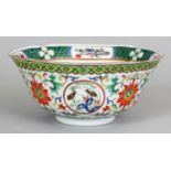 A CHINESE FAMILLE VERTE PORCELAIN BOWL, with indented rim, the sides painted with bird medallions
