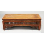 A 19TH/20TH CENTURY CHINESE OR TIBETAN LOW RECTANGULAR TABLE, the pierced frieze carved with archaic