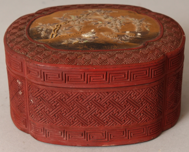 A JAPANESE MEIJI PERIOD RED CINNABAR LACQUER, & SHIBAYAMA BOX & COVER, of quatrefoil section, the