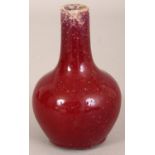 ANOTHER SMALL 18TH/19TH CENTURY CHINESE FLAMBE BOTTLE VASE, the streaked red glaze turning to purple