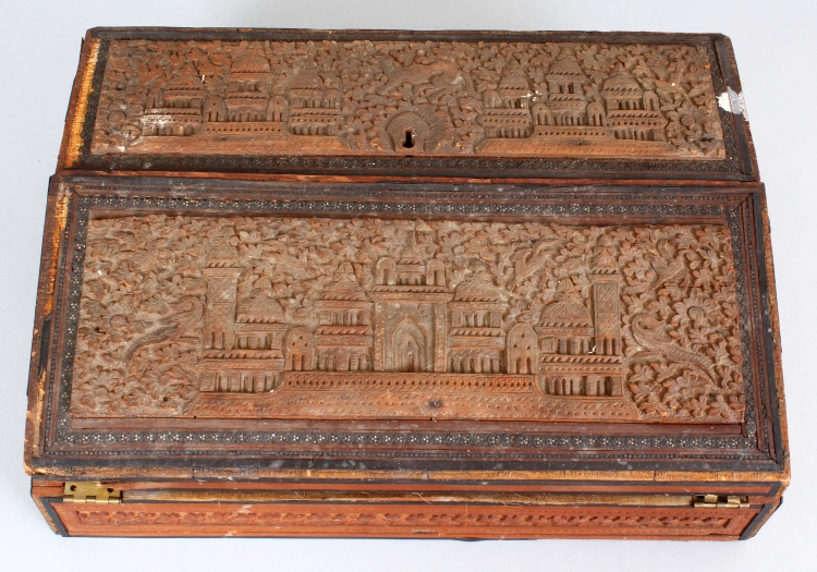 A 19TH CENTURY INDIAN CARVED SANDALWOOD WRITING BOX, with folding slope and lidded compartment, 13.