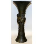 A JAPANESE MEIJI/TAISHO PERIOD BRONZE BEAKER VASE, cast in high relief with an insect resting on