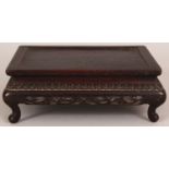 A 19TH/20TH CENTURY CHINESE RECTANGULAR CARVED HARDWOOD STAND, with pierced foliate frieze and