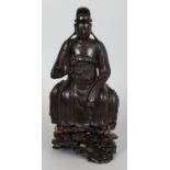 A GOOD CHINESE MING DYNASTY BRONZE FIGURE OF A SEATED OFFICIAL, together with a fitted carved