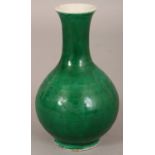 A SMALL 19TH CENTURY CHINESE APPLE GREEN MONOCHROME PORCELAIN VASE, the base with a four-character