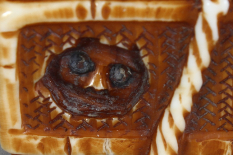 A SIGNED JAPANESE MEIJI PERIOD STAINED IVORY NETSUKE OF A DEMON, lying astride a rectangular reed - Image 6 of 9