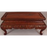 A FINE QUALITY 19TH CENTURY CHINESE RECTANGULAR CARVED HARDWOOD LOW STAND OR TABLE, the frieze