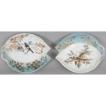 A PAIR OF EARLY 20TH CENTURY SIGNED JAPANESE MOULDED PORCELAIN LEAF DISHES, one painted with two